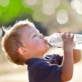 A boy drinking of a bottle of water
