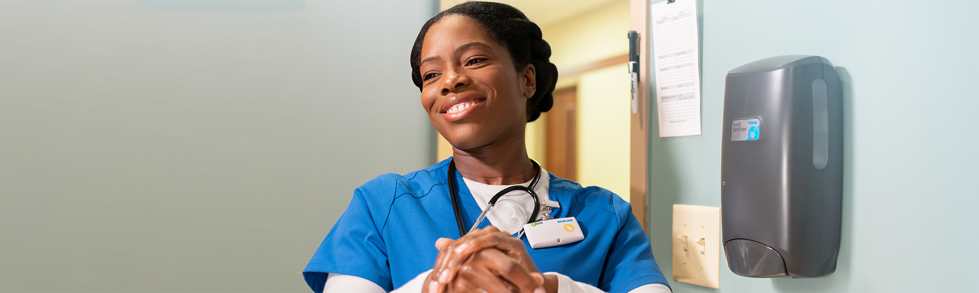 Healthcare worker cleaning hands with an Ecolab hand care product